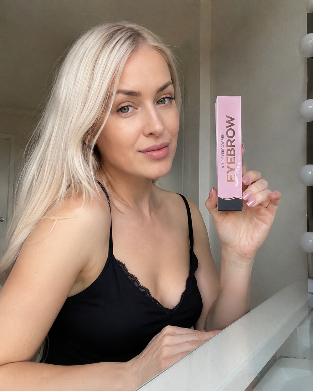 Customer holding the 4-Tip Eyebrow Pen box at home